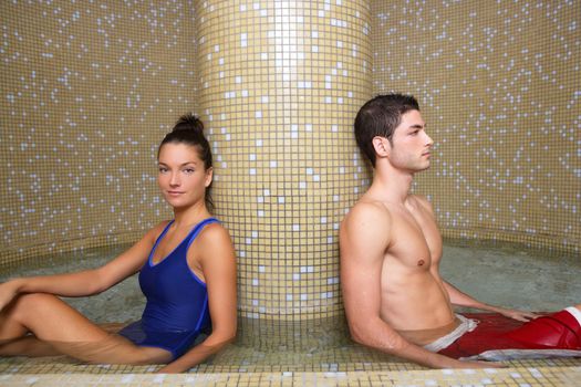 Couple young in cool spa water round pool after sauna therapy