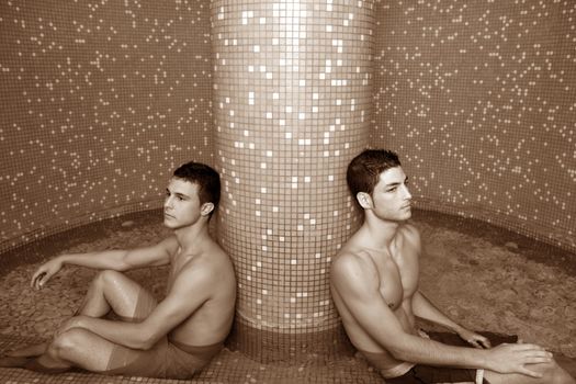two young spa men sitting pool cold water therapy after sauna