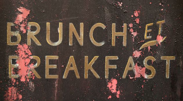 A Grungy French Brunch And Breakfast Sign Outside A Restaurant