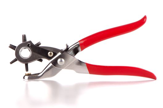 Tool used to pierce belts and shoes on white background.