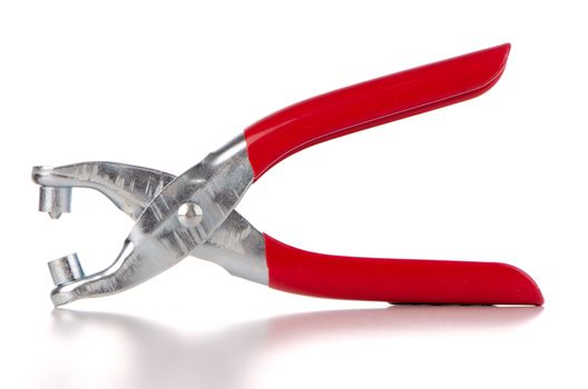 Tool used to pierce belts and shoes on white background.