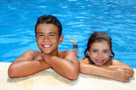 teen boy and little girl summer vacation in blue swimming pool