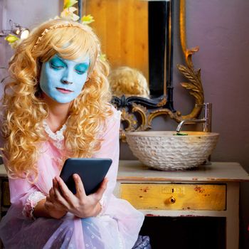 Humor woman in bathroom with ebook tablet and green mask