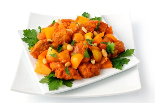 Pork in batter with pineapple and bell pepper in sweet and sour sauce with peanuts