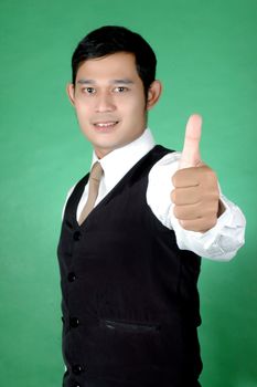 asian young man thumbs-up against green background