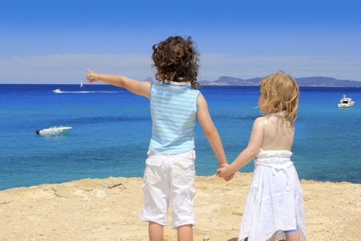 two sister girls summer Cala Saona looking blue sea Formentera Balearic