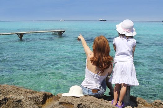 mother ans daughter tourist formentera turquoise sea point finger