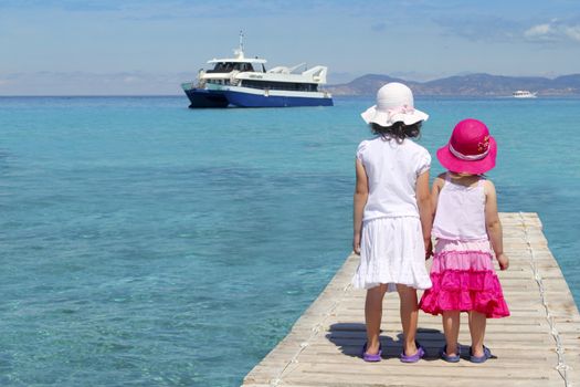 little sisters tourist turquoise sea back in Formentera