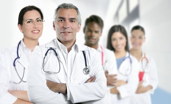 expertise gray hair doctor multiracial nurse team row over white