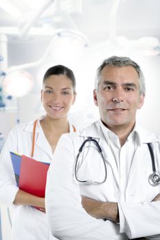 expertise gray hair doctor beautiful nurse in hospital white corridor