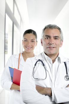 expertise gray hair doctor beautiful nurse in hospital white corridor