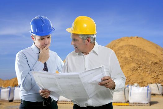 architect engineer two expertise team plan talking hardhat quarry sand sacks blue sky