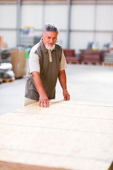 Senior man buying construction wood in a  DIY store