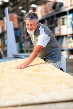 Senior man buying construction wood in a  DIY store