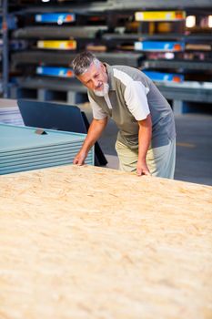 Senior man buying construction wood in a  DIY store