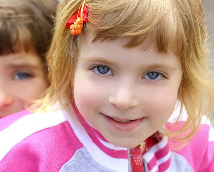 blond little beautiful girl portrait funny gesturing blue eyes face