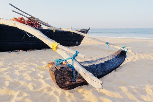 Old wooden fishing boat on the sandy beach