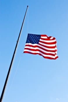 American flag on a blue sky during a windy day