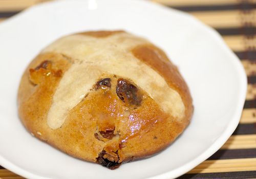 Cross bun with raisin and dried apricots