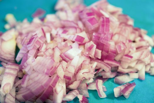 sOME chopped red onions on chopping board
