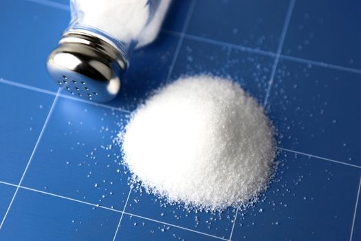 Salt shaker on wooden table