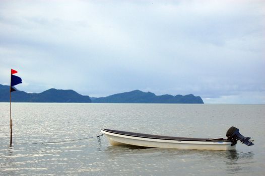 Laid up speedboat and flag, Papua New Guinea