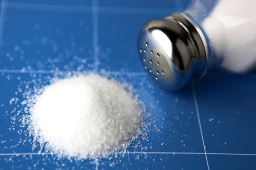 Salt shaker on wooden table