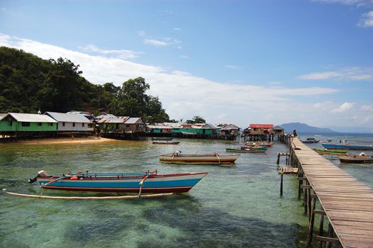 Timber town pier with jukung boats, Jayapura,West Papua, Indonesia