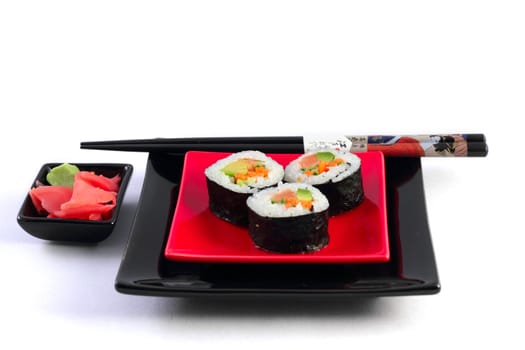 Sushi on black plate on the white background