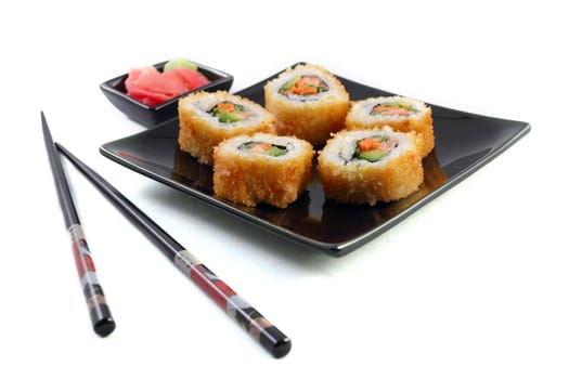 Sushi on black plate on the white background