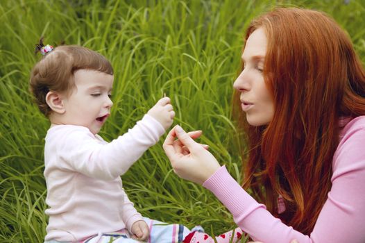 beautiful mother and baby little girl outdoor park garden grass playing