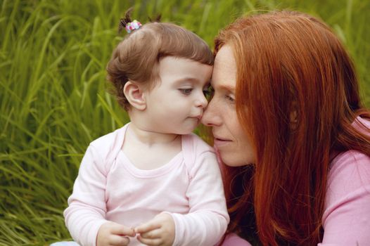 beautiful mother and baby little girl outdoor park garden grass playing