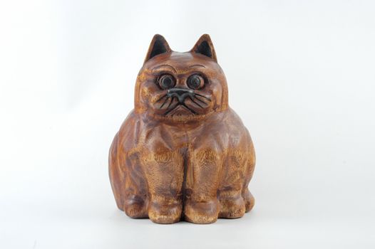 Fat brown wooden cat on white background