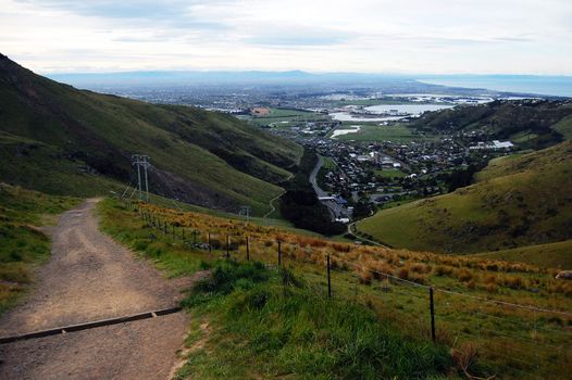 Gravel road down to valley Christchurch view, New Zealand