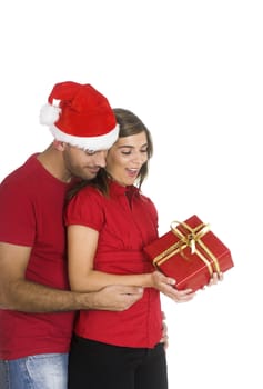 Happy couple holding a Christmas present isolated on white