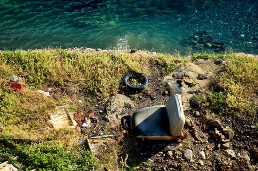 Driver's seat dumped near sea with other garbage