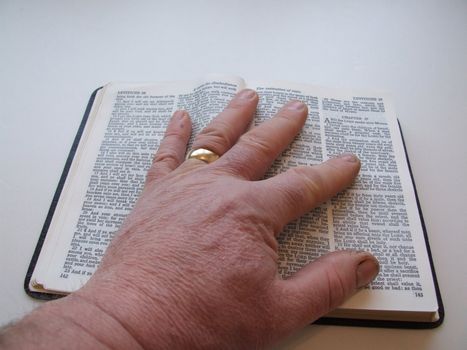 Hand on bible as if taking an oath