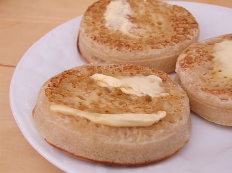 close shot of three hot buttered crumpets