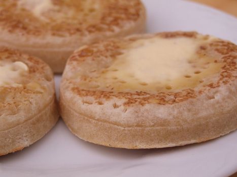 close up shot of hot buttered crumpets