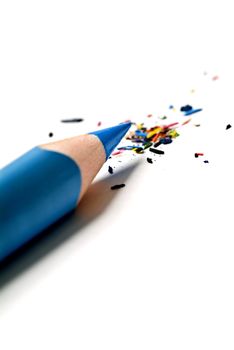 blue pencil and multi colored shavings isolated on white