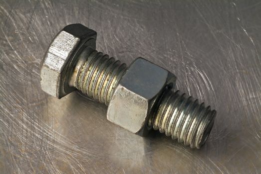 bolt and nut on metalic background
