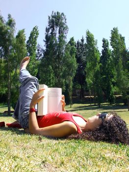 young girl reading book in park