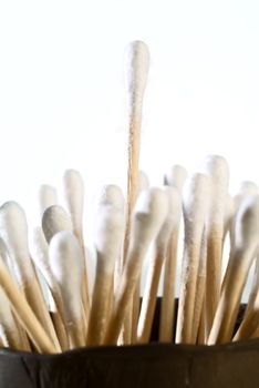 detail of group of cotton tipped applicators with one sticking out