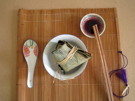 serving a food of glutinous rice wrapped in leaves for special occasion