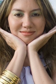 A half japanese, half german model, with gold bracelets, close-up.