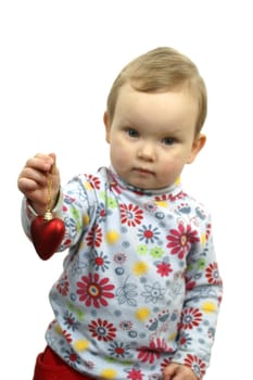 Baby girl with  red glass heart isolated on white background