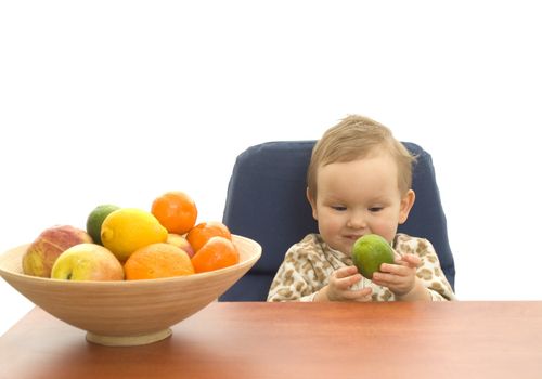 Baby and fresh fruits on table isolated background