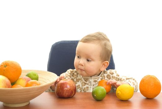 Baby and fresh fruits on table isolated background