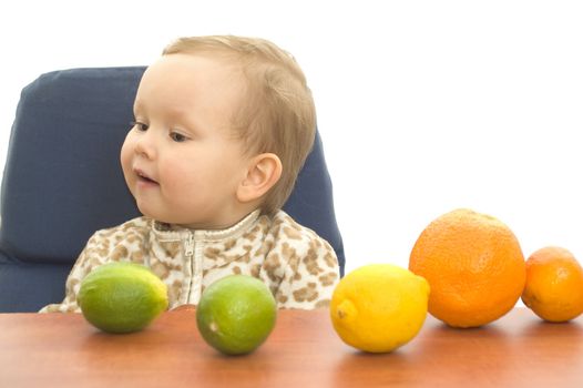 Baby and fresh fruits on table isolated background