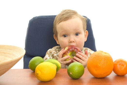 Baby and fresh fruits on table isolated background